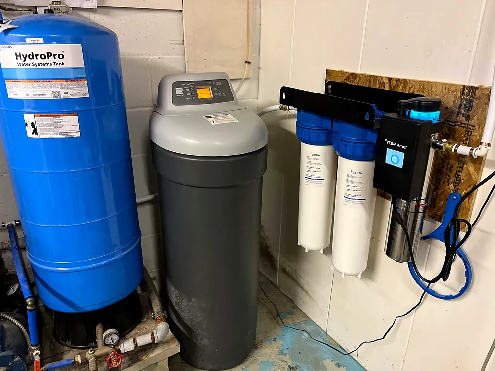 Pressure tank, water softener, filters and UV system installed on a wall